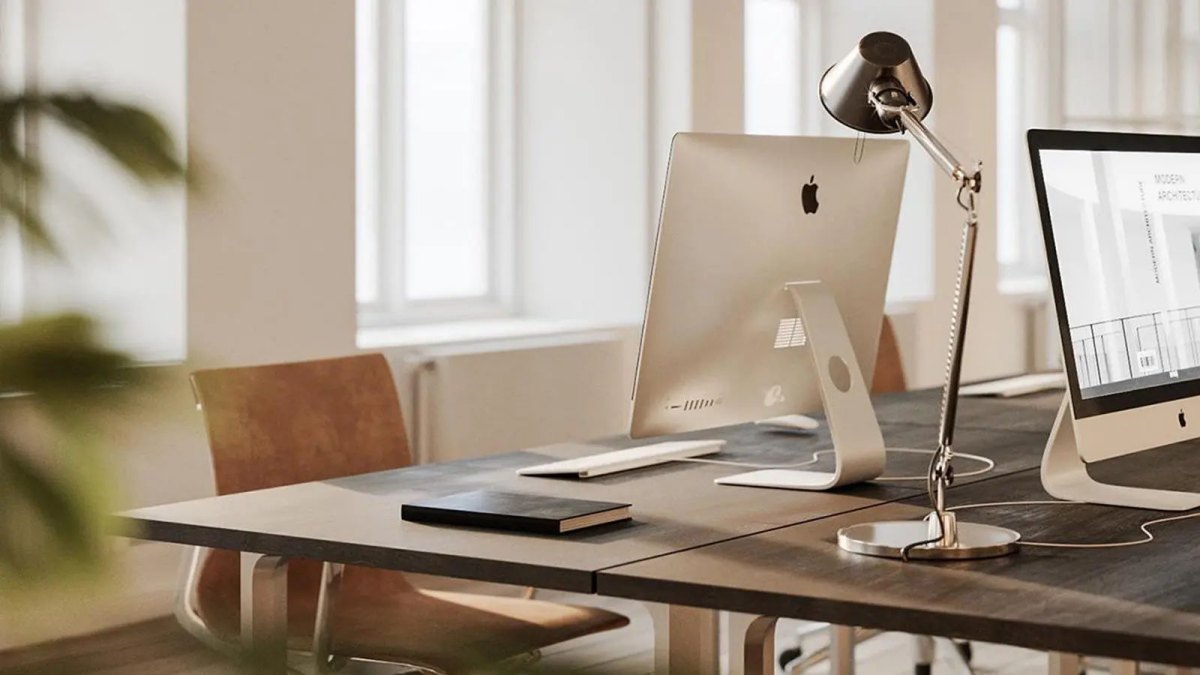 Văn phòng hiện đại với bàn làm việc gọn gàng, máy tính iMac, đèn bàn; hình nền HD 1200x675, không gian làm việc tối giản.